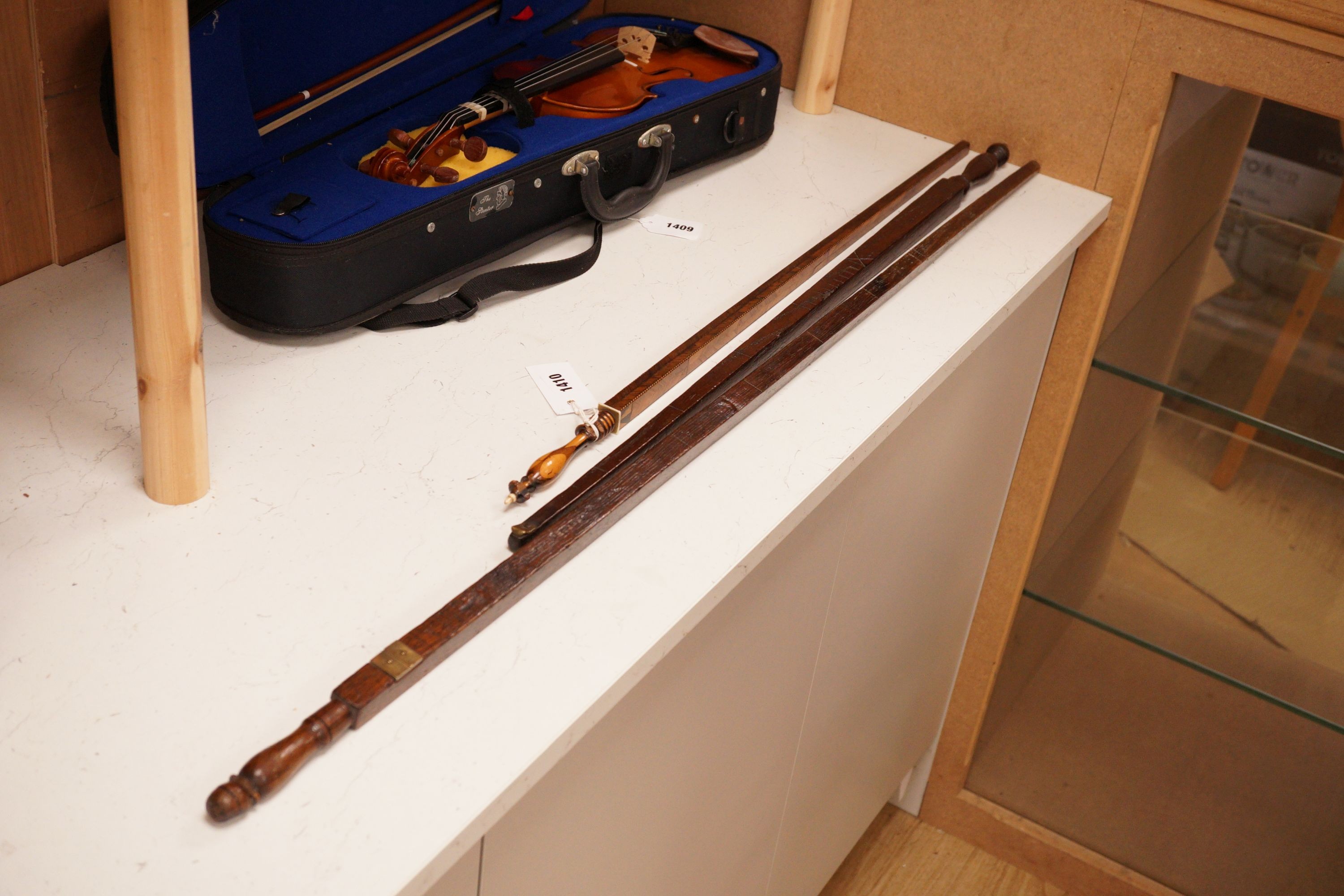 Three assorted 19th century treen measuring sticks to include a kingwood feather banded and marquetry inlaid measuring stick with stickware finial